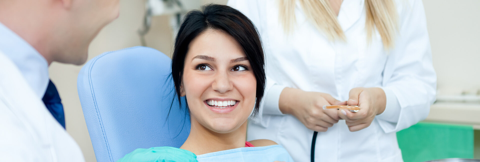 Woman smiling showing her bright white teeth at dental clinic
